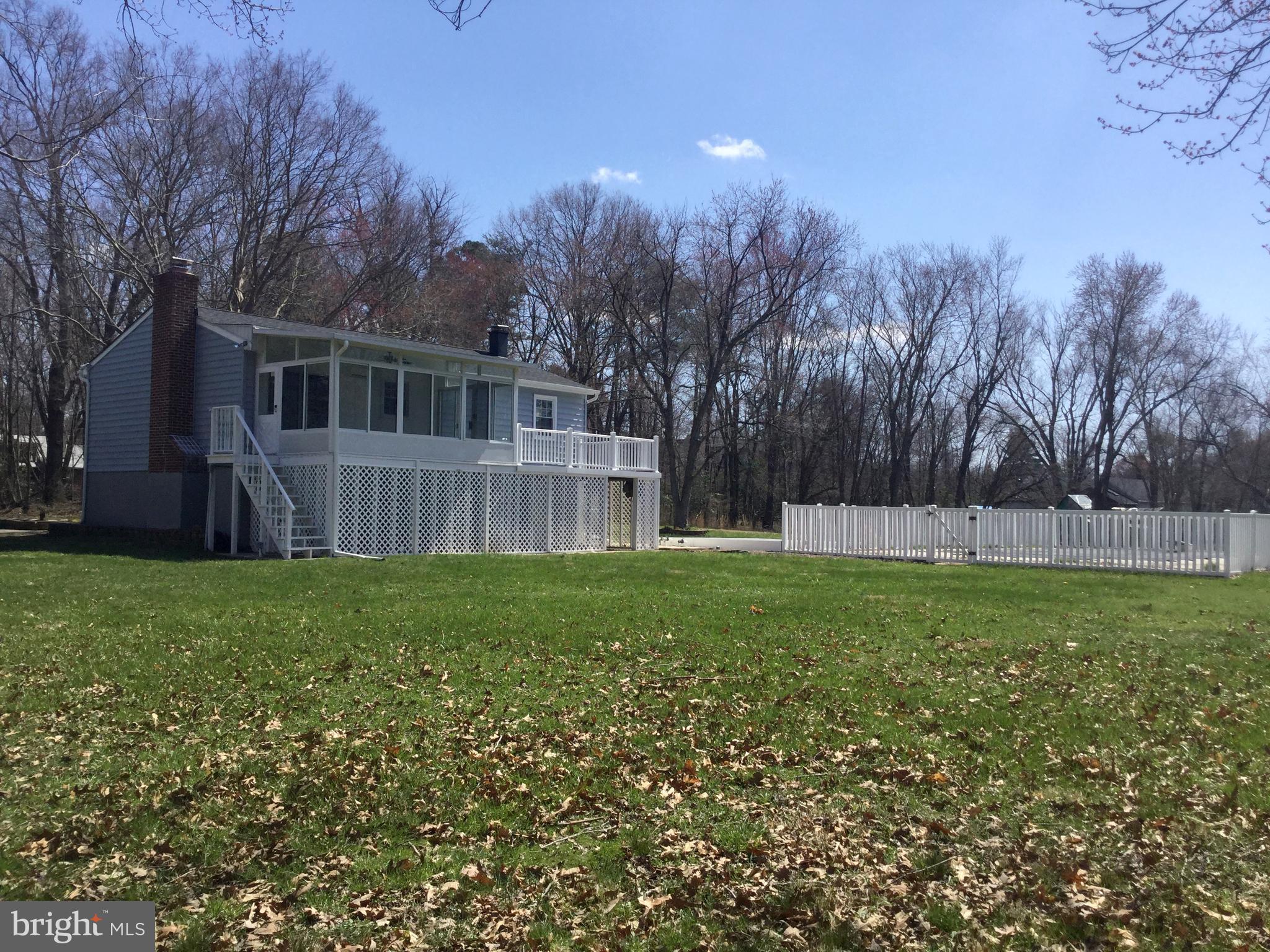 7764 Telegraph Road Severn, MD 21144 - Photo 24 of 24 a view of a backyard with a garden and trees