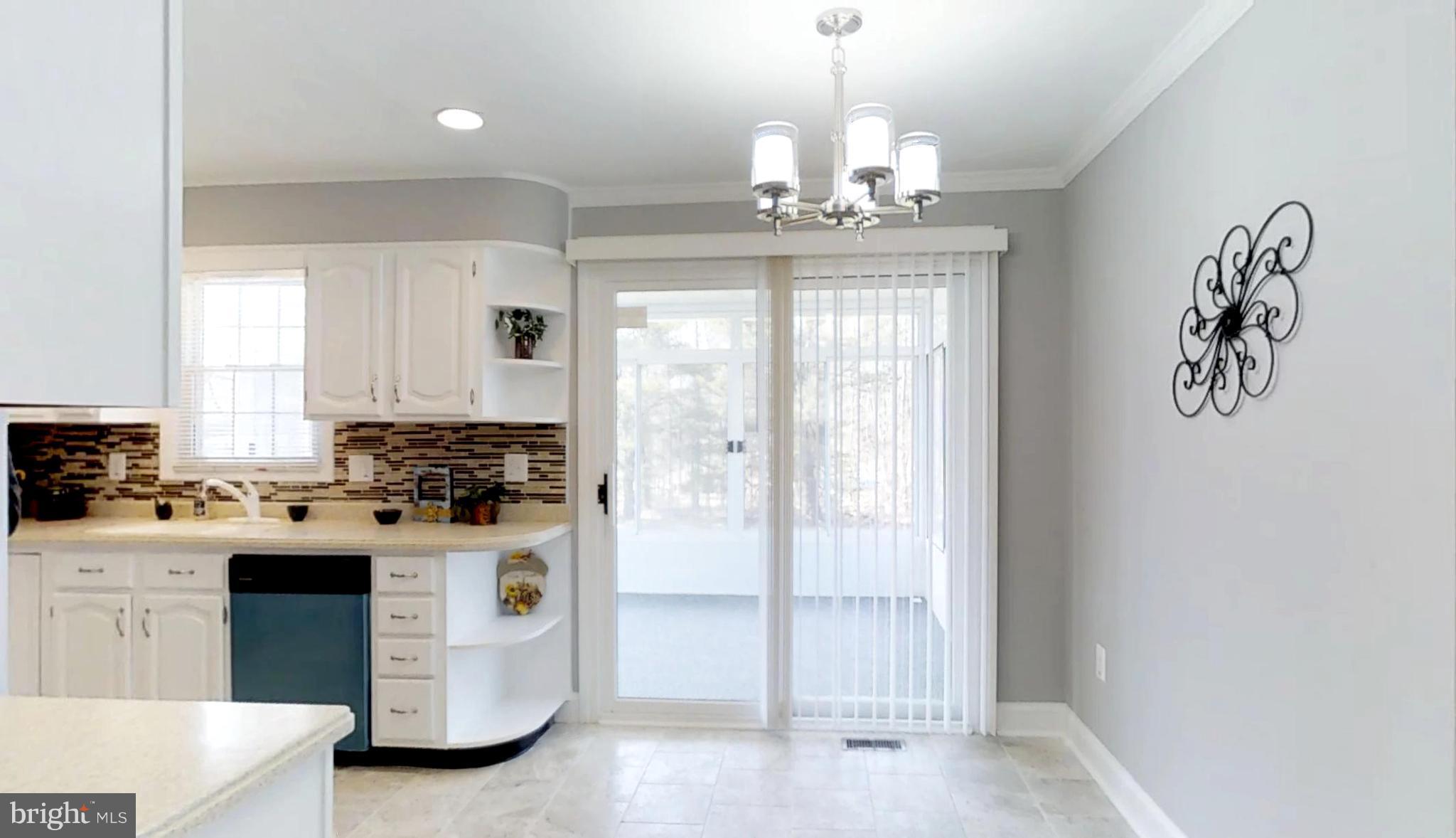 7764 Telegraph Road Severn, MD 21144 - Photo 4 of 24 a kitchen with a stove and white cabinets