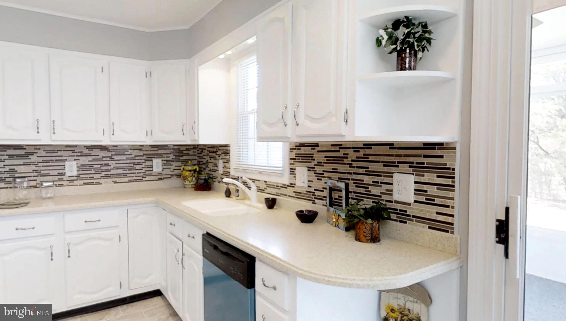 7764 Telegraph Road Severn, MD 21144 - Photo 5 of 24 a kitchen with a sink a stove and cabinets