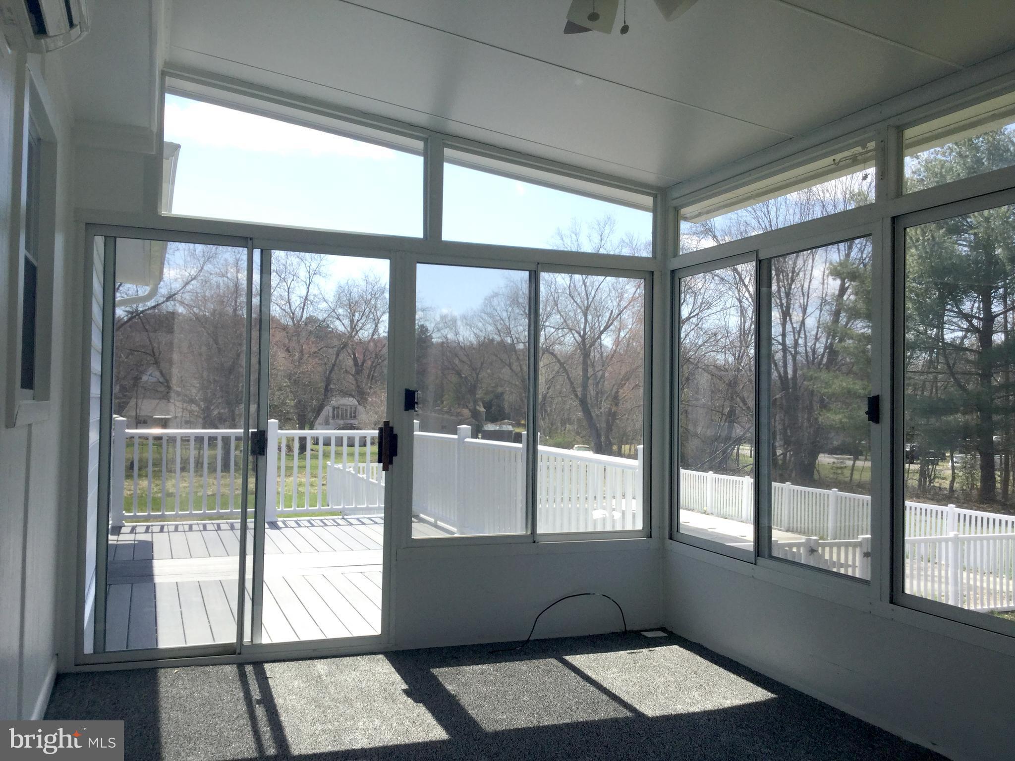 7764 Telegraph Road Severn, MD 21144 - Photo 7 of 24 a living room with a large window and a table