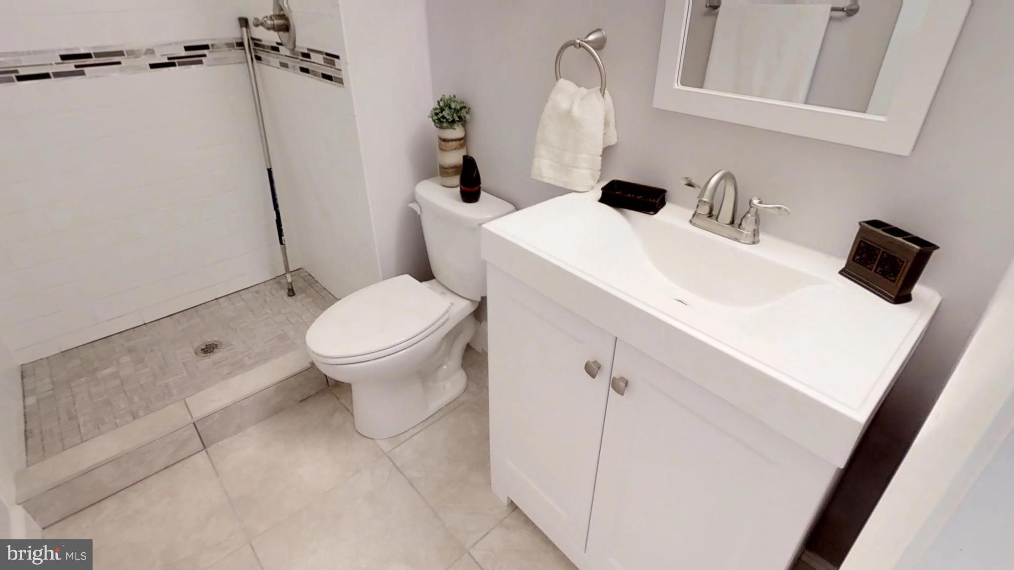 7764 Telegraph Road Severn, MD 21144 - Photo 10 of 24 a bathroom with a sink and toilet