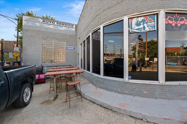a backyard of a house with barbeque oven table and chairs
