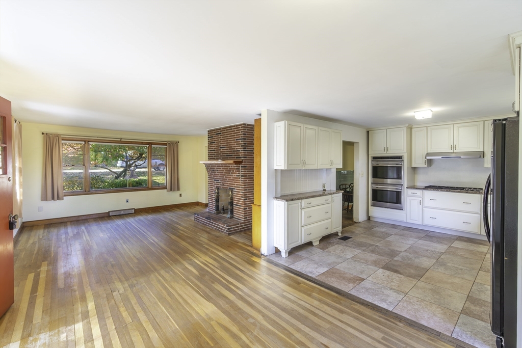 84 Bethany Road Framingham, MA 01702 - Photo 13 of 38 a kitchen with stainless steel appliances a refrigerator and wooden floor