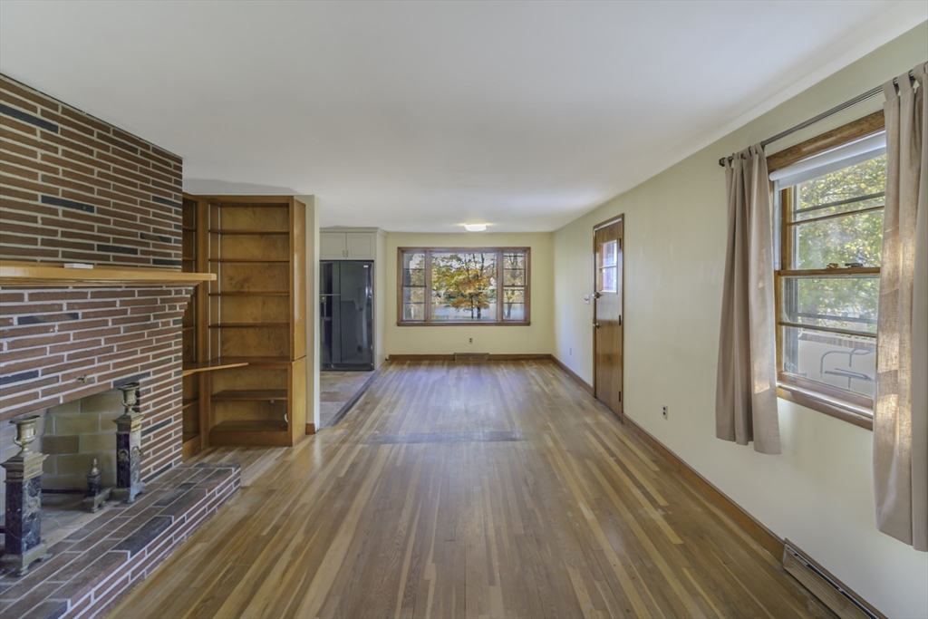84 Bethany Road Framingham, MA 01702 - Photo 15 of 38 a view of a hallway with wooden floor and a fireplace