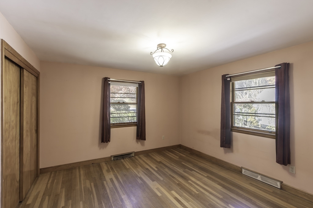 84 Bethany Road Framingham, MA 01702 - Photo 20 of 38 an empty room with wooden floor cabinet and windows