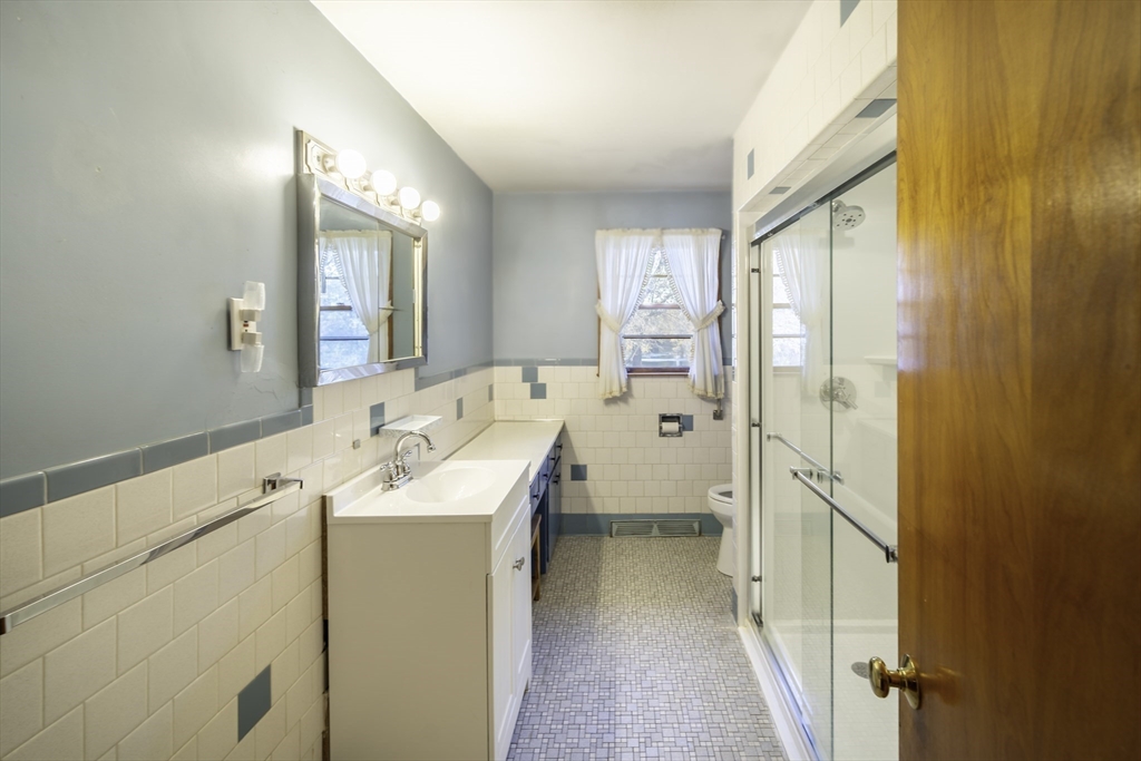 84 Bethany Road Framingham, MA 01702 - Photo 23 of 38 a bathroom with a sink a mirror and a shower