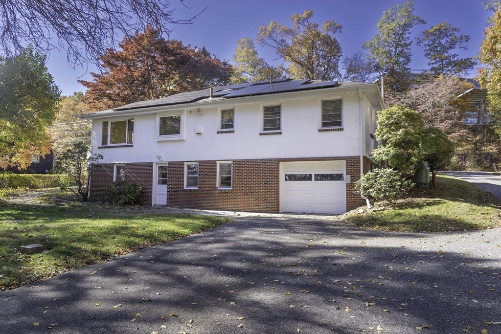 84 Bethany Road Framingham, MA 01702 - Photo 32 of 38 a front view of a house with a yard and a garage