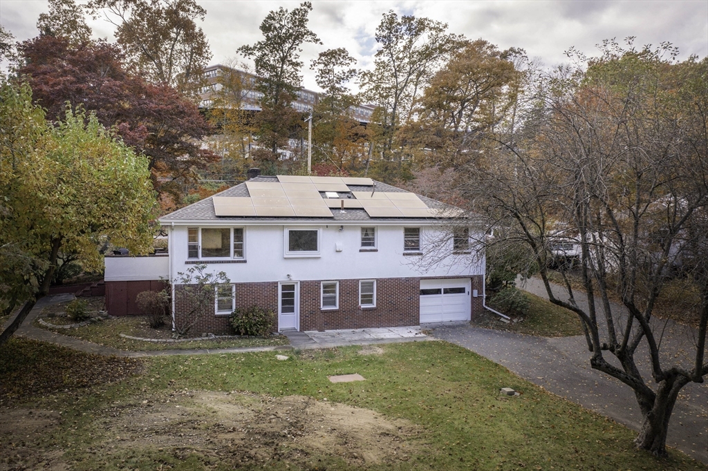 84 Bethany Road Framingham, MA 01702 - Photo 5 of 38 a front view of a house with a garden and tree