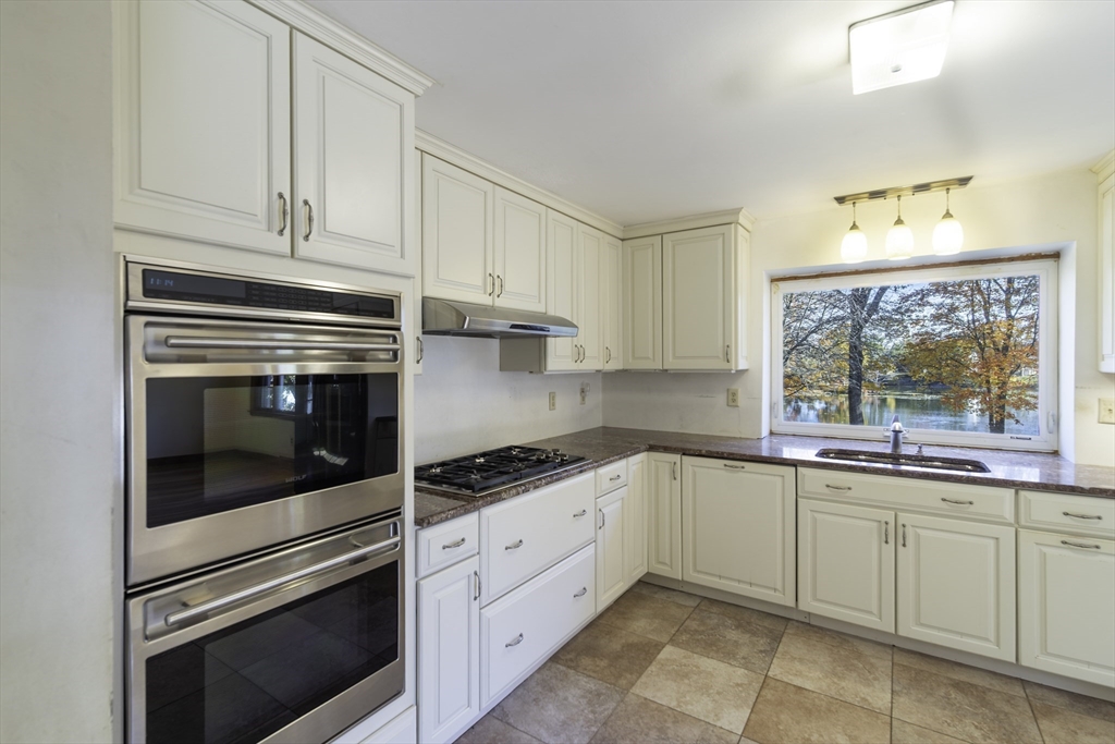 84 Bethany Road Framingham, MA 01702 - Photo 9 of 38 a kitchen with granite countertop white cabinets and appliances