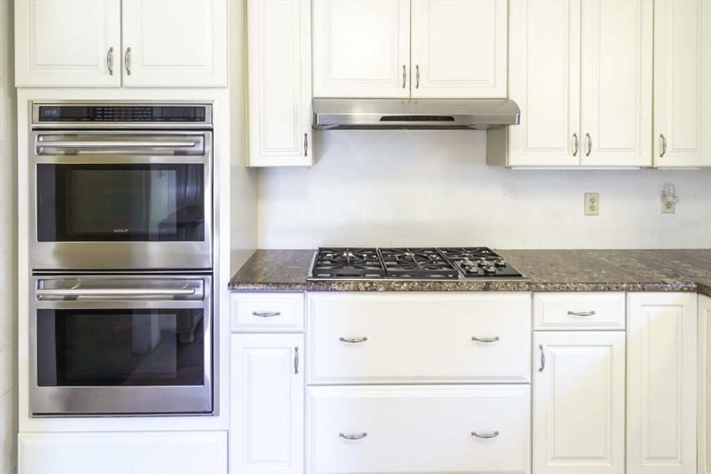 84 Bethany Road Framingham, MA 01702 - Photo 10 of 38 a stove top oven sitting inside of a kitchen