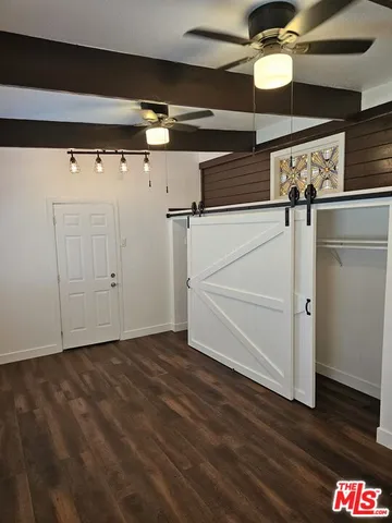 a view of a room with wooden floor
