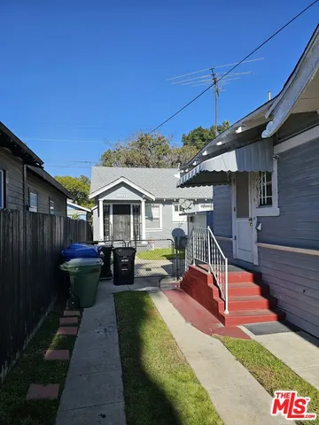 a view of a house with backyard water fountain and sitting area