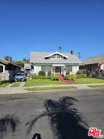 a aerial view of a house with a yard and balcony