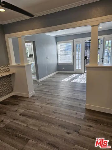 a view of empty room with wooden floor