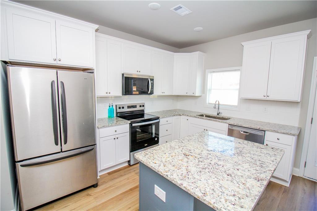 96 Boogies Run Commerce, GA 30529 - Photo 7 of 28 a kitchen with stainless steel appliances granite countertop a refrigerator stove microwave and sink