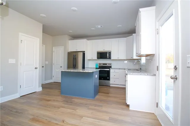 a kitchen with refrigerator and microwave
