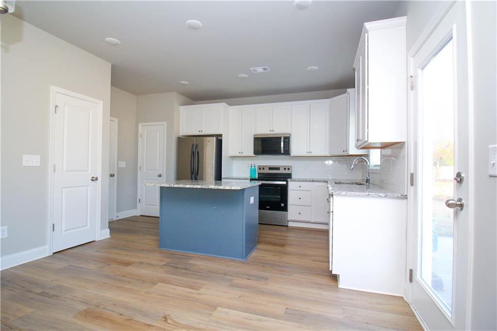 96 Boogies Run Commerce, GA 30529 - Photo 8 of 28 a kitchen with refrigerator and microwave