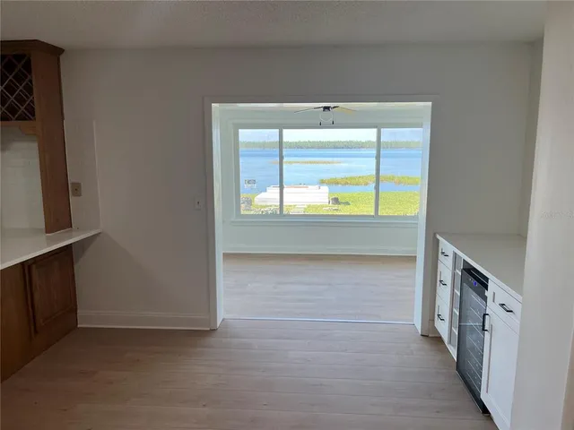 a view of an empty room with a fireplace and cabinet