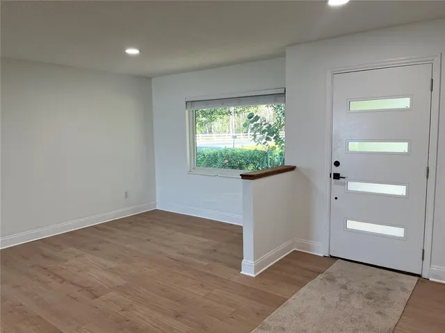 an empty room with windows and entrance