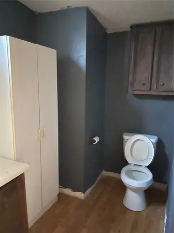 a white toilet sitting next to a bathroom sink