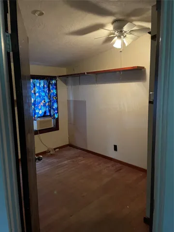 a view of an empty room and a window