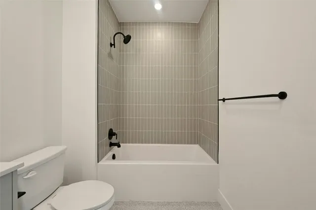 a bathroom with a bathtub and a toilet