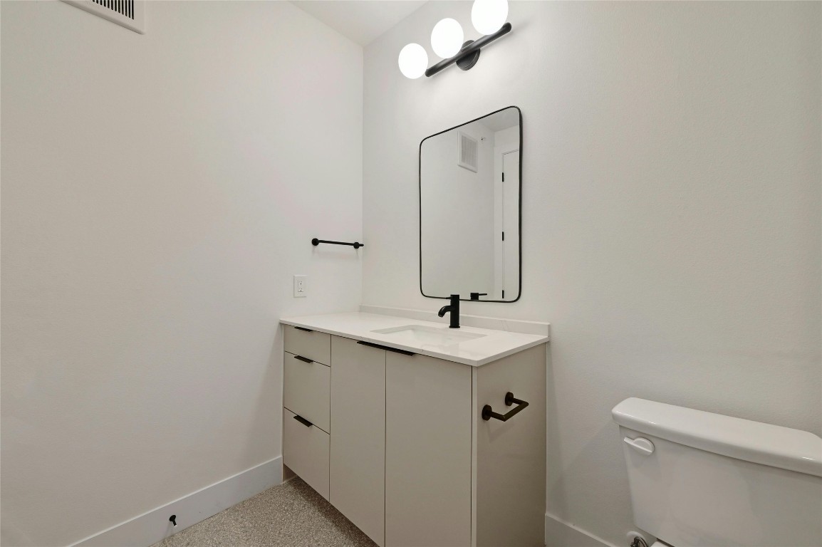 1701 Simond Avenue, Unit 328 Austin, TX 78723 - Photo 20 of 35 a bathroom with a toilet sink and mirror
