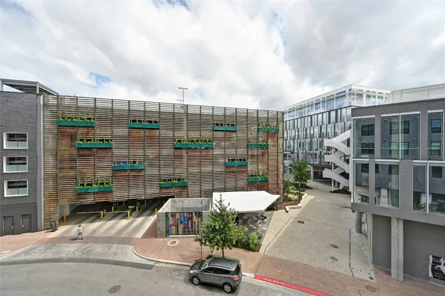 a view of a swimming pool with a lounge chairs in front of building