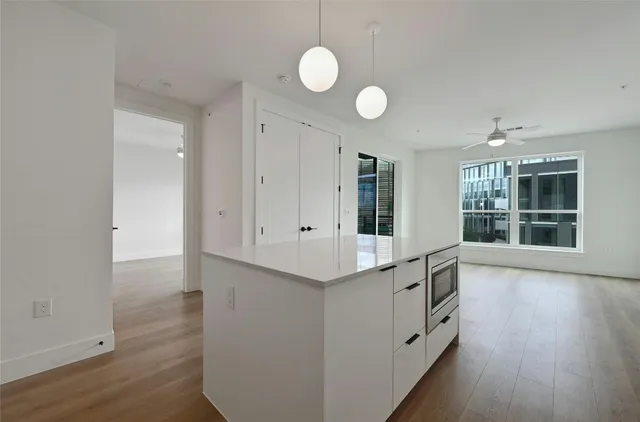 an entryway with wooden floor and windows