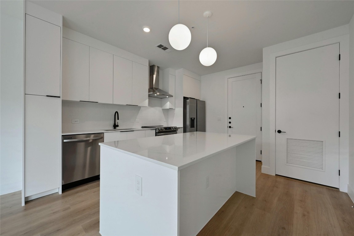 1701 Simond Avenue, Unit 328 Austin, TX 78723 - Photo 6 of 35 a kitchen with cabinets and stainless steel appliances