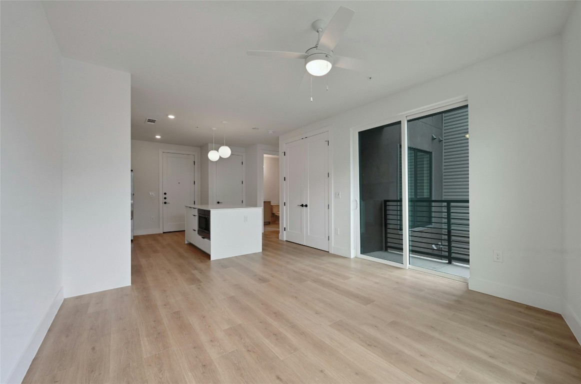 1701 Simond Avenue, Unit 328 Austin, TX 78723 - Photo 10 of 35 an empty room with wooden floor and windows