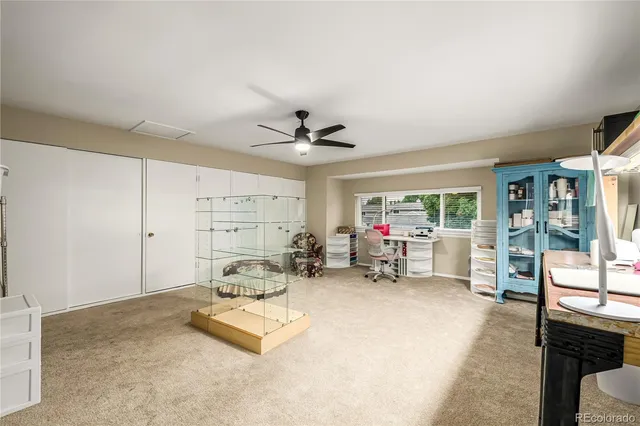 a living room with furniture a flat screen tv and a large window