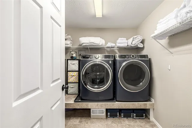 a view of a patio with table and chairs wooden floor and fence
