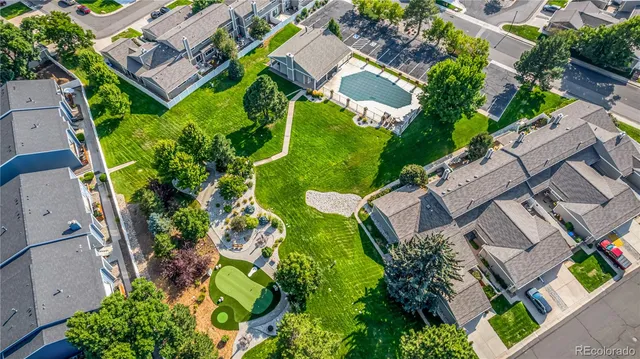 an aerial view of residential houses with outdoor space and swimming pool