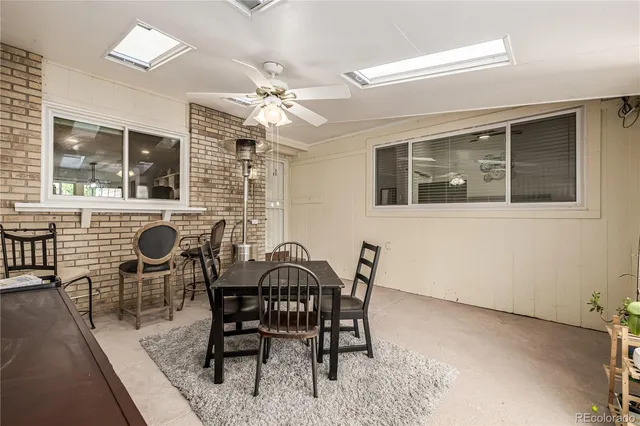 a view of a dining room with furniture and chandelier