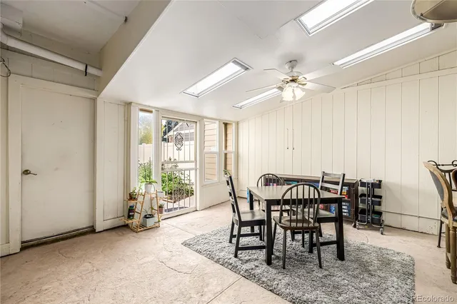 a view of a dining room with furniture and a chandelier