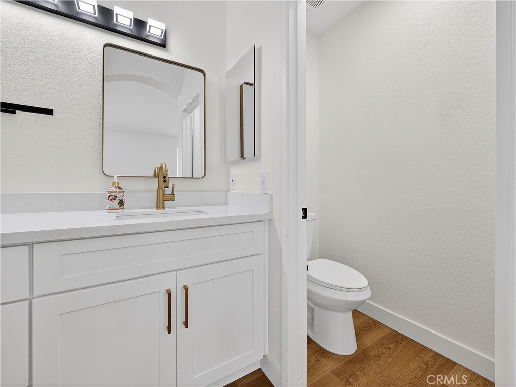 1436 Riviera Avenue Banning, CA 92220 - Photo 28 of 43 a bathroom with a toilet sink and mirror