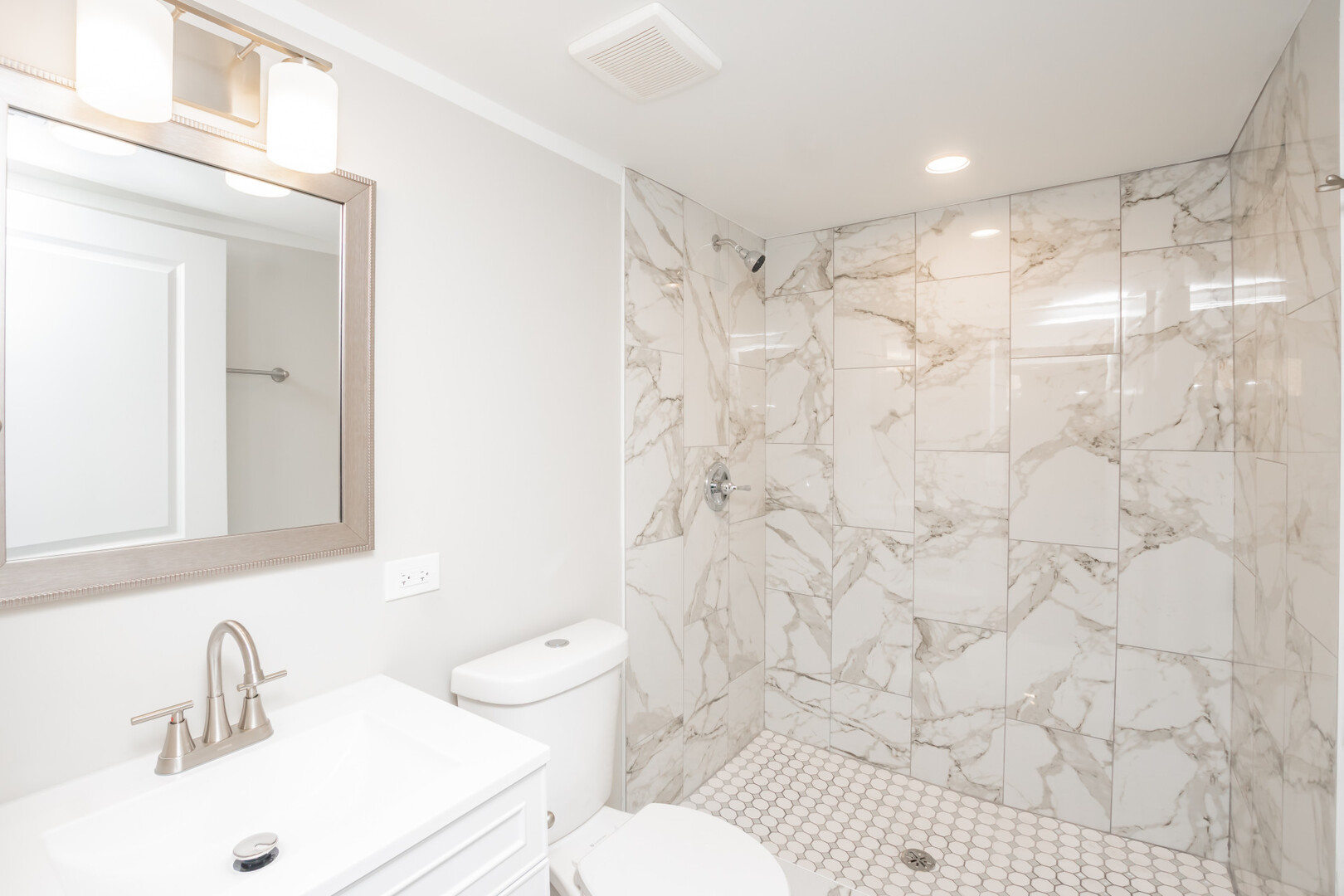 9800 South Drexel Avenue Chicago, IL 60628 - Photo 15 of 16 a bathroom with a sink toilet and shower