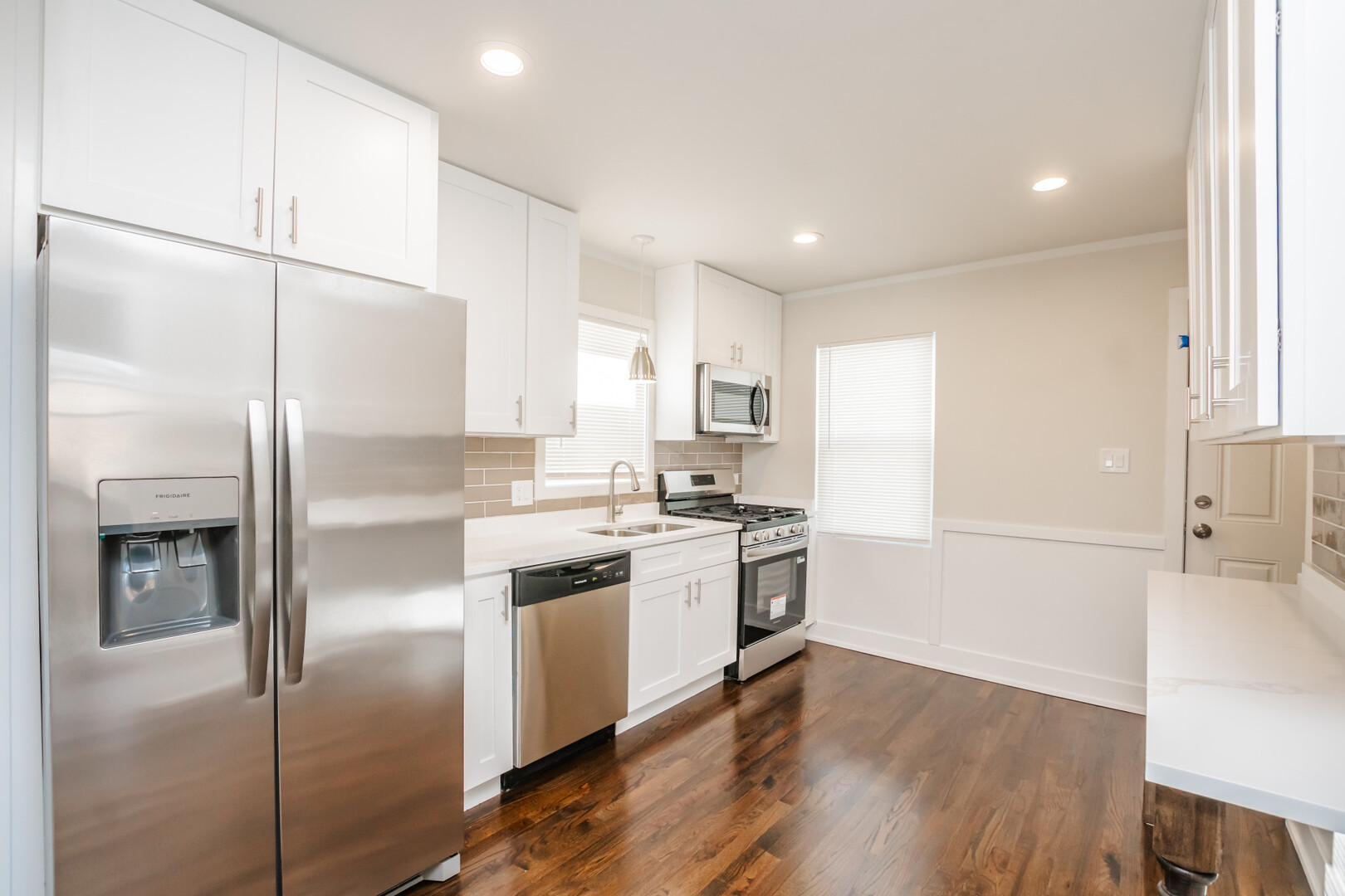 9800 South Drexel Avenue Chicago, IL 60628 - Photo 6 of 16 a kitchen with a refrigerator a sink and a stove top oven