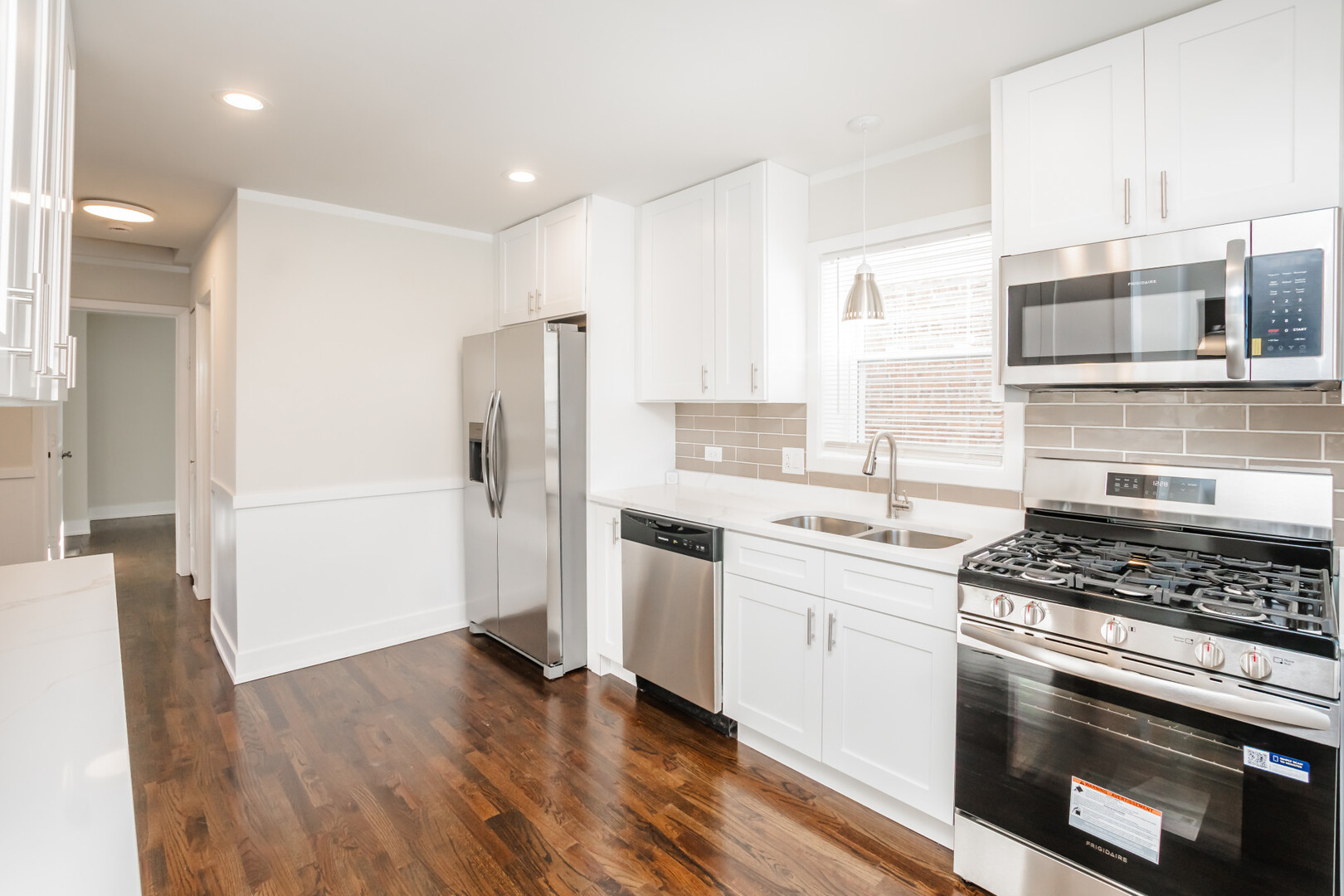 9800 South Drexel Avenue Chicago, IL 60628 - Photo 7 of 16 a kitchen with stainless steel appliances granite countertop a stove and a refrigerator