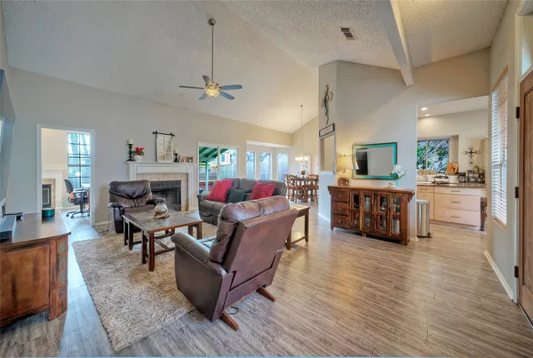 a living room with furniture ceiling fan and a rug
