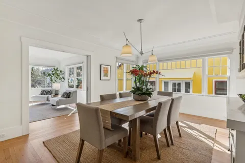 a view of a dining room with furniture wooden floor and chandelier