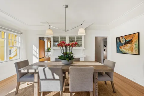 a view of a dining room with furniture window and wooden floor