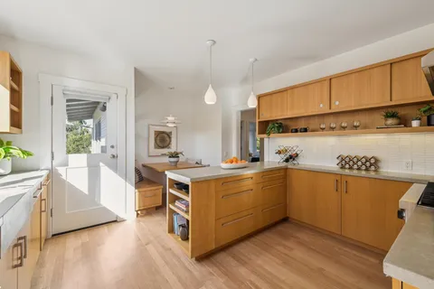 a kitchen with stainless steel appliances granite countertop a sink stove and cabinets