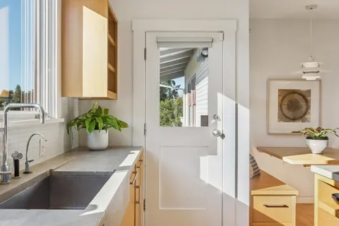 a kitchen with a refrigerator a sink and a window
