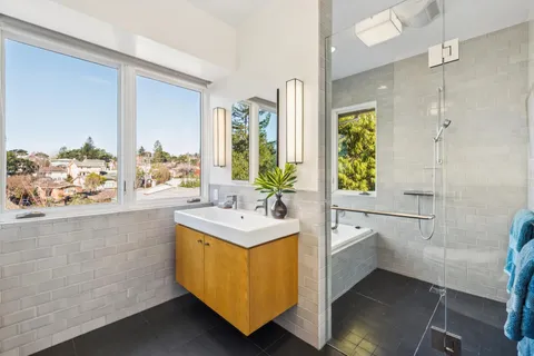 a bathroom with a toilet sink and mirror