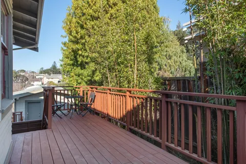 a view of a livingroom with wooden floor and a ceiling fan
