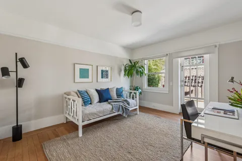 a living room with furniture and a potted plant