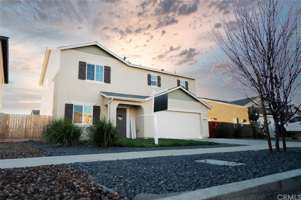385 Ostrander Avenue Merced, CA 95341 - Photo 1 of 12 a view of a white house with a yard