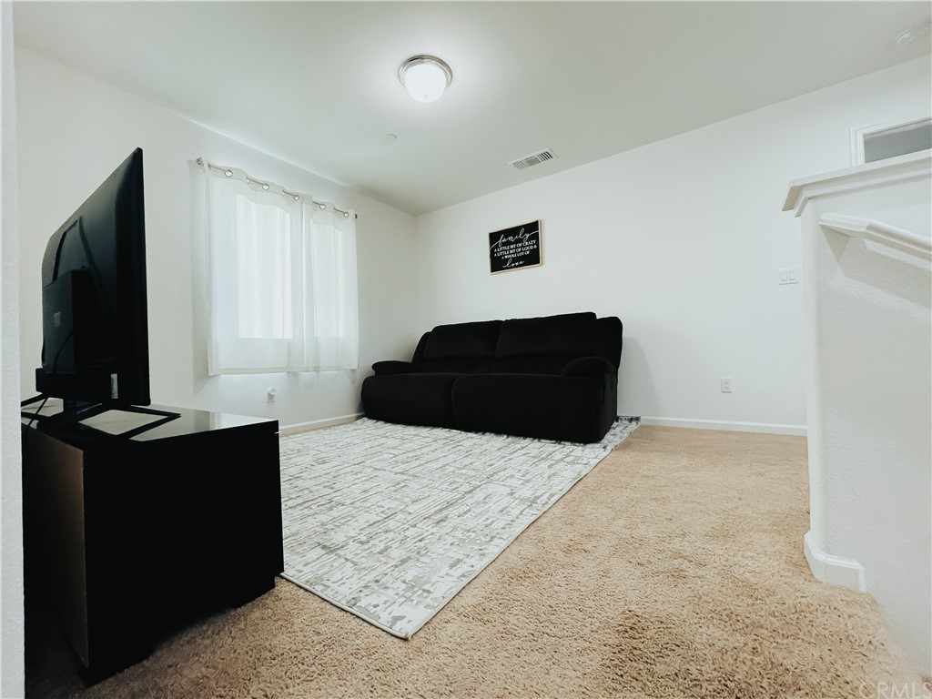 385 Ostrander Avenue Merced, CA 95341 - Photo 12 of 12 a bedroom with a bed and a flat tv screen on dresser